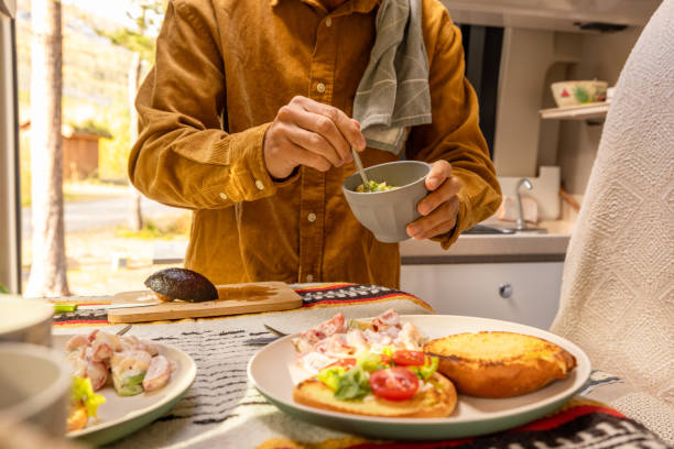 istock Man preparing food inside his camper van. Camping concept 1499731195