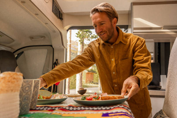 istock Man preparing food inside his camper van. Camping concept 1499731205
