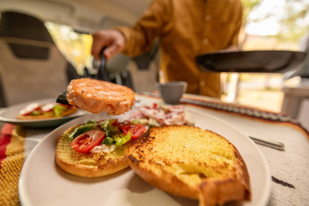 istock Man preparing food inside his camper van. Camping concept 1499731264