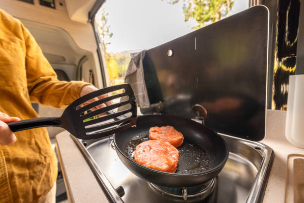 istock Man preparing food inside his camper van. Camping concept 1499731296