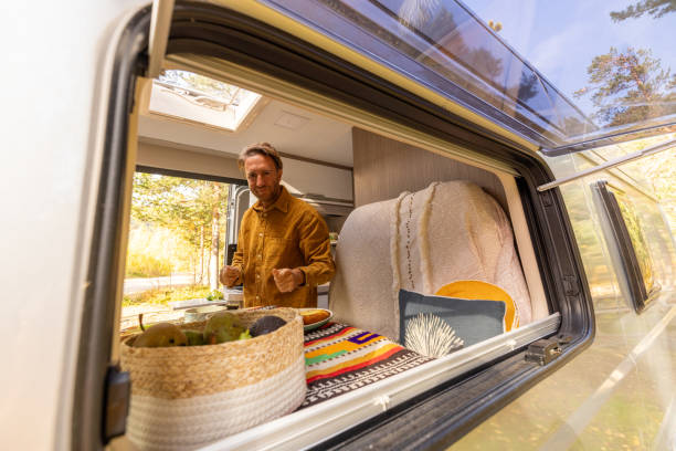 istock Man preparing food inside his camper van. Camping concept 1499731494