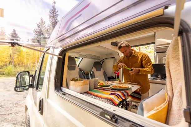istock Man preparing food inside his camper van. Camping concept 1499731685