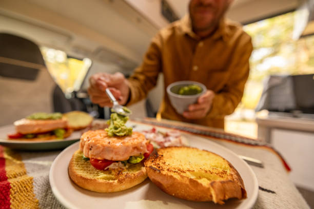 istock Man preparing food inside his camper van. Camping concept 1499731766