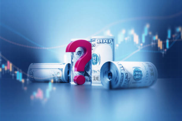 Rolled up American dollar banknotes and red question mark over financial graph. Horizontal composition with copy space. Business and finance concept.