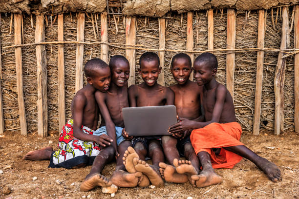 Group of African children using laptop, Kenya, East Africa
