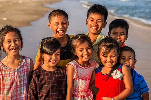 Group of happy Vietnamese children on the beach, Vietnam