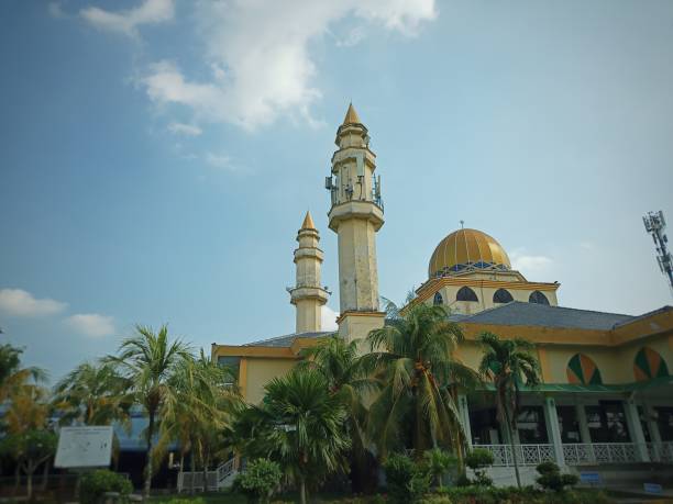 istock A landscape view of a mosque surrounded by trees with clouds and blue sky background. 1499733714