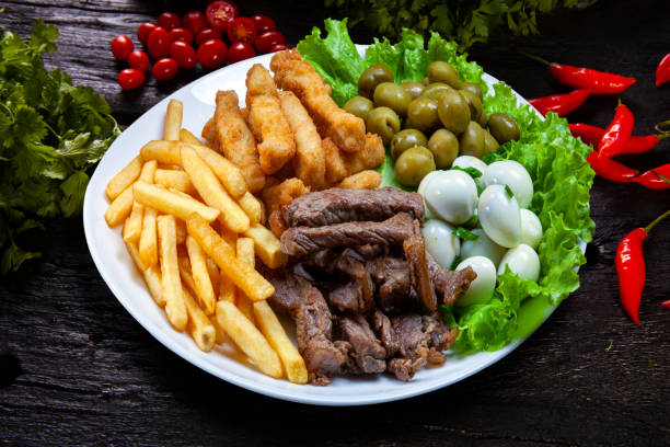 istock Snacks with fries, meat Picanha, quail egg, olives and breaded fish 1499734600