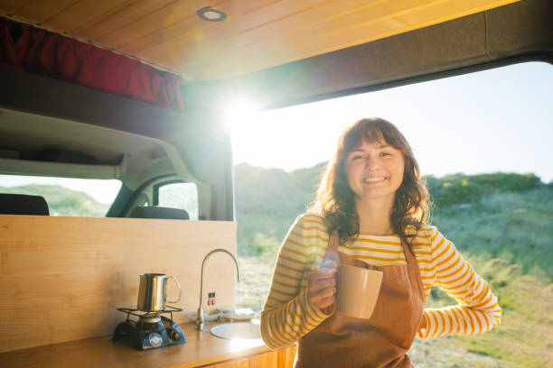 istock Woman in apron drinking coffee in  the camper van 1499734643