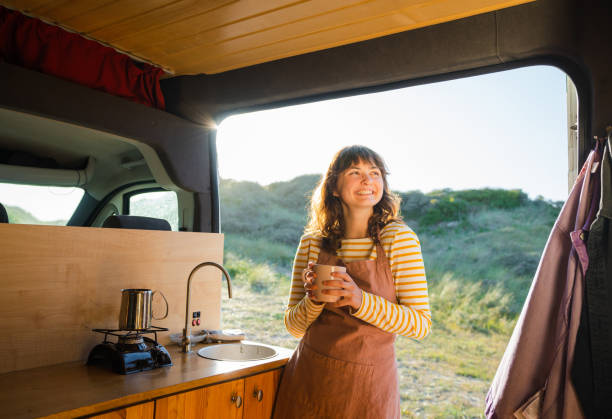 istock Woman in apron drinking coffee in  the camper van 1499734916