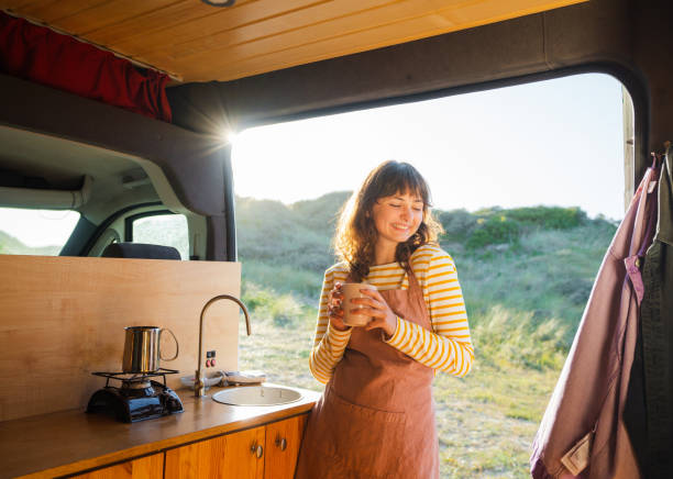 istock Woman in apron drinking coffee in  the camper van 1499734920