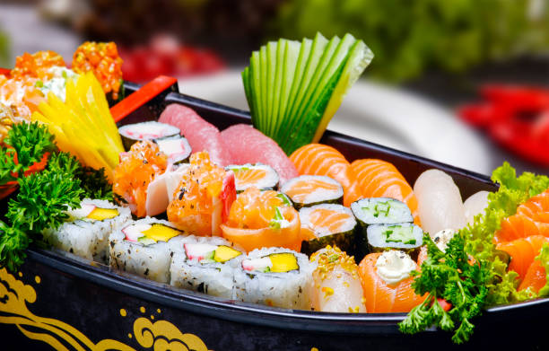 istock Sushi sashimi set in a wooden boat on a brown 1499735014