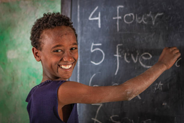 african little boy is learning english language - education blackboard africa youth culture imagens e fotografias de stock