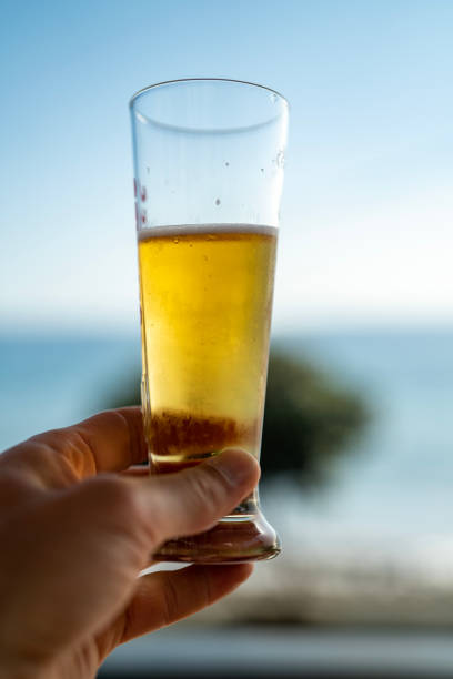 istock Toasting with a glass of beer vertical image 1499735519