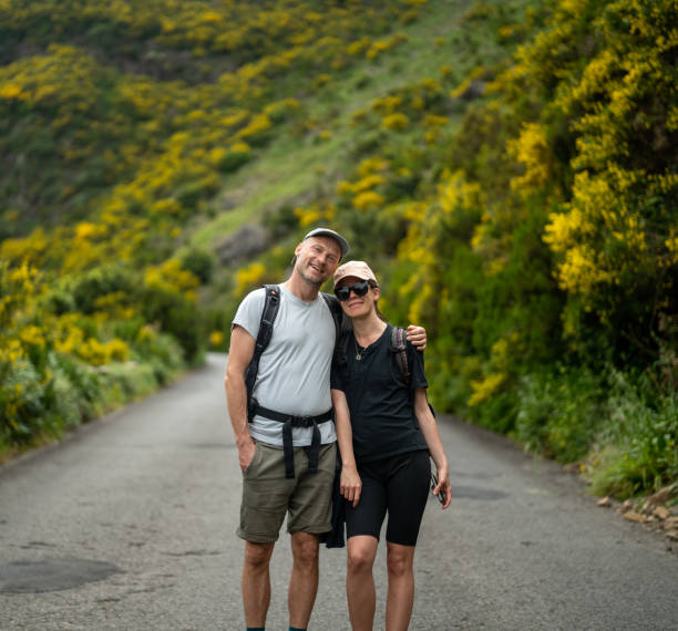 istock Tourists enjoying tropical climate and walking down a road embracing 1499736411