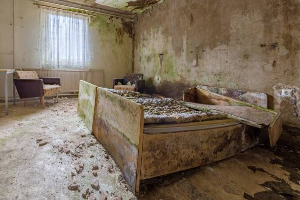 istock Decay in a room with a double bed and a chair 1499736436