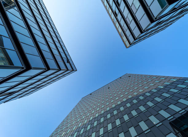 istock Low angle view of modern office buildings against clear blue sky 1499739751