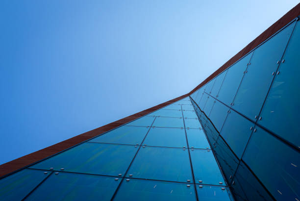 istock Low angle view of modern office buildings against clear blue sky 1499739752