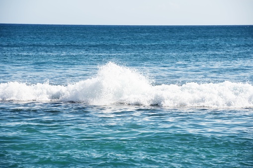 A scenic view of sea waves on a sunny day