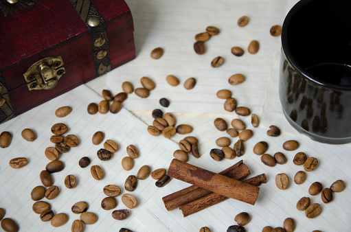 Coffee beans, wooden box, black cup, cinnamon
