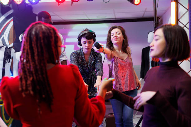 istock Club singer giving microphone to people 1499740619