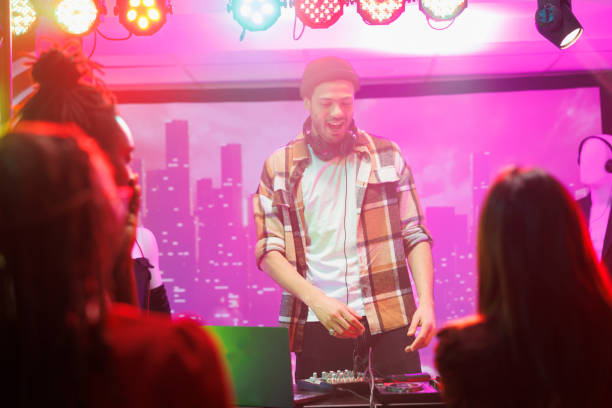 istock Dj on stage controlling music in club 1499743465