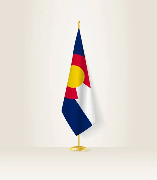 Vector illustration of Colorado flag on a flag stand.