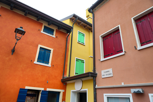 Colorful facades of houses in old town Caorle, Italy.