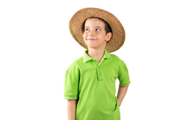 Vacation boy wearing hat wearing green t-shirt over isolated white background thinking about question, pensive expression. thoughtful face