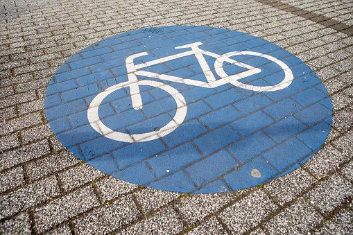 Road section with road markings regulating the movement of cyclists. Bicycle signs on the road. Bicycle road with arrow. Bicycle and modern ecological public movement.