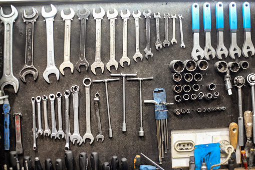 Group of various work tools on gray background.