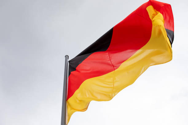 istock Germany national flag with an overcast sky 1499747258