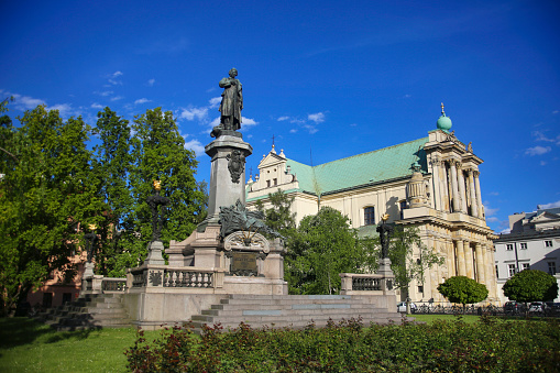Monument of Adam Mickiewicz and the Carmelite Church in Warsaw, Poland.