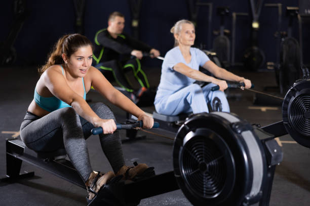 istock Athlete woman works on rowing simulator in gym 1499748961