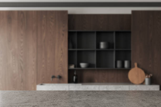 istock Grey stone countertop on background of kitchen interior with kitchenware. Mockup 1499752518