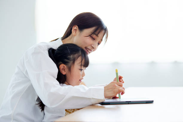 istock Mother and daughter drawing on a tablet 1499753069