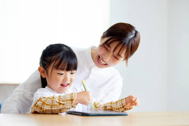istock Mother and daughter drawing on a tablet 1499753071
