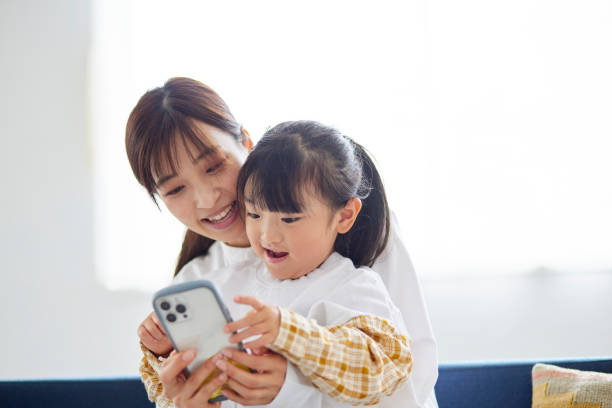 istock Mother and daughter using a smartphone 1499753654