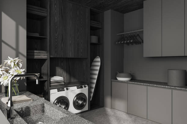 istock Grey interior of laundry room with washing machine and iron table 1499753827
