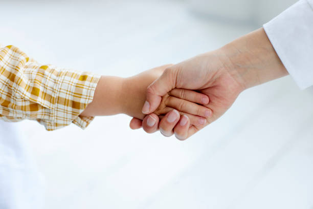 istock mother's hand holding child's hand 1499753962