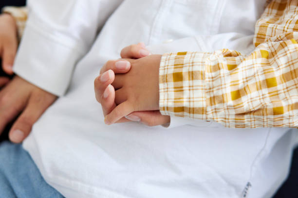 istock mother's hand holding child's hand 1499753971