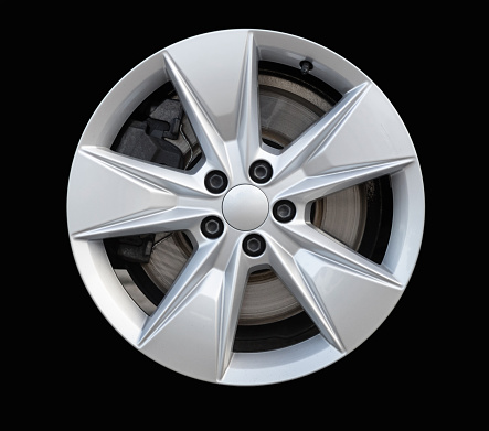 Car wheel on white background. Isolated car tire with shiny rim from front view. 3d rendering, nobody
