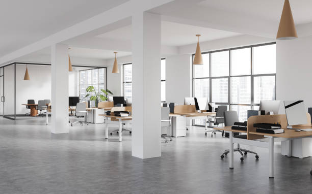 istock White office room interior with desk in row, pc computer and panoramic window 1499754230