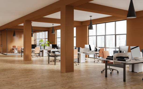 istock Orange office room interior with desk in row, pc computer and panoramic window 1499754294