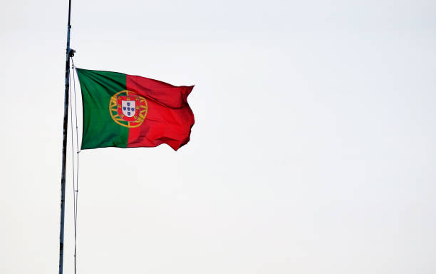 Portuguese flag waving in the wind against a clear sky