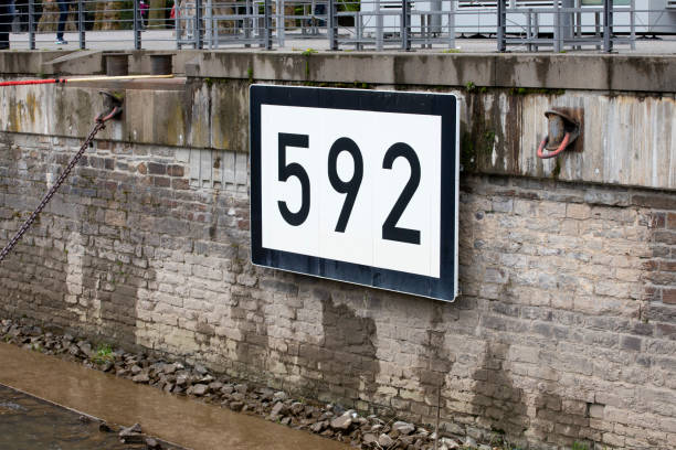Number 592 on a riverbank wall