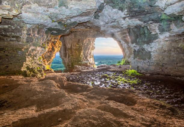 istock Scenic view of sunset over a landscape seen from a cave 1499762578