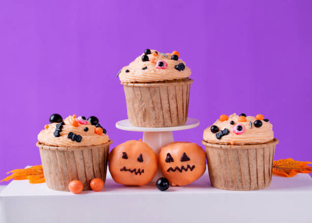 istock Halloween cupcakes with orange cream and festive sugar sprinkles 1499765437