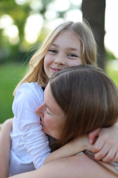 istock Cheerful mother and daughter hugging, portrait. 1499765576