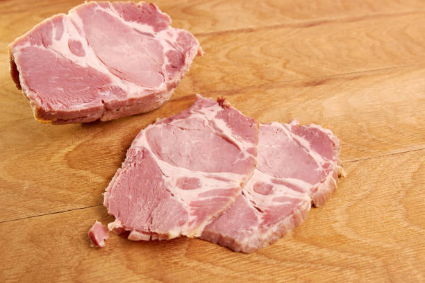 istock Ham meat cut into slices on a wooden board. 1499765931